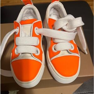 These are boy/ girls bright beautiful orange kids Christian Louboutin sneakers.